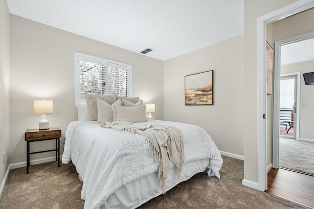 bedroom with visible vents, baseboards, and carpet floors