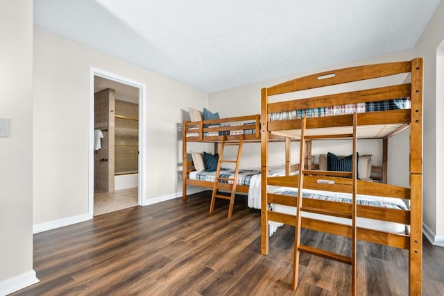 bedroom with baseboards and wood finished floors