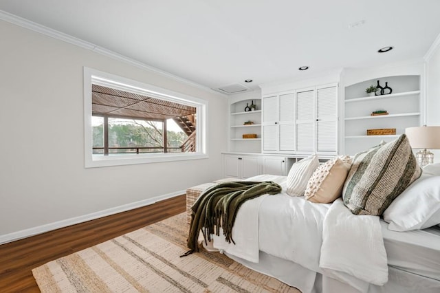 bedroom with crown molding, dark wood-type flooring, and baseboards