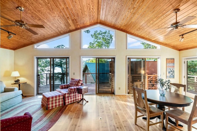 sunroom with lofted ceiling, wood ceiling, ceiling fan, and track lighting