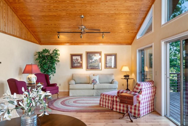 living area with wood finished floors, wooden ceiling, rail lighting, and vaulted ceiling