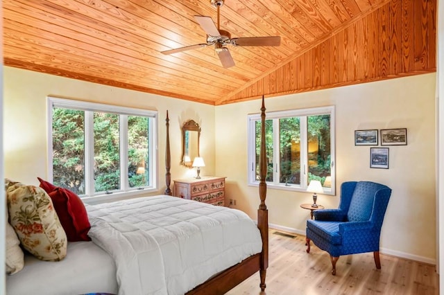 bedroom featuring wood ceiling, multiple windows, vaulted ceiling, and light wood-style flooring