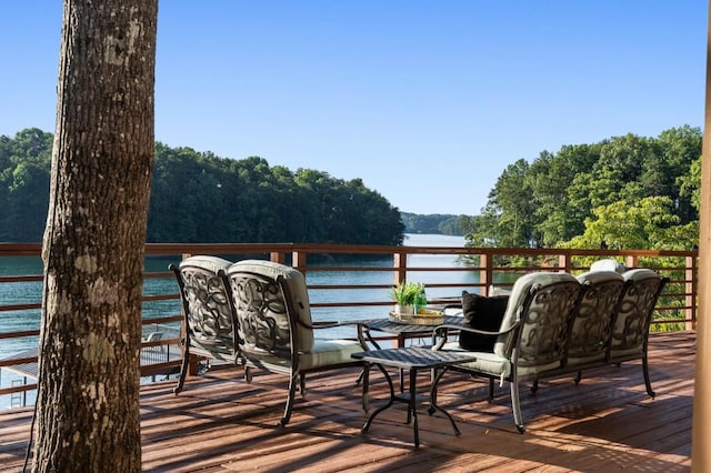 wooden terrace with a view of trees and a water view