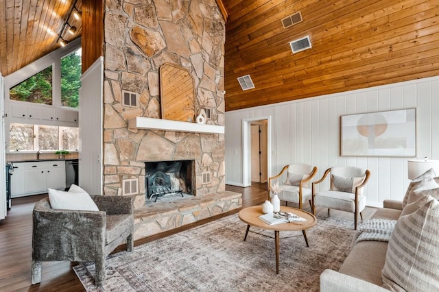 living area featuring visible vents and a fireplace