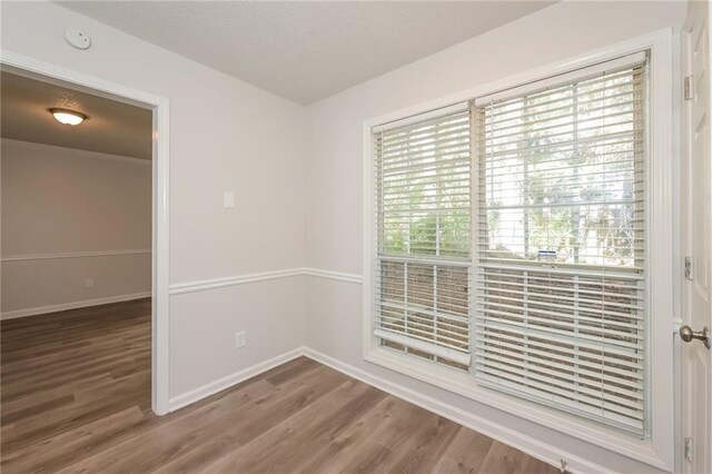 spare room with hardwood / wood-style floors