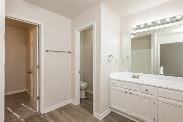 bathroom featuring hardwood / wood-style floors, vanity, and toilet