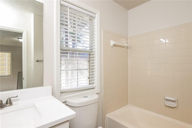 full bathroom with tiled shower / bath, a wealth of natural light, vanity, and toilet