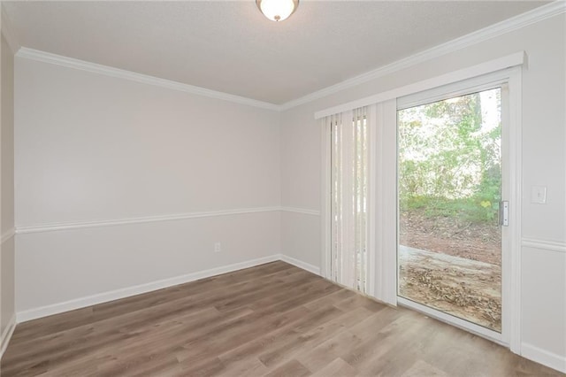 empty room with crown molding and wood-type flooring