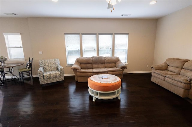 living room featuring ceiling fan, a healthy amount of sunlight, and dark hardwood / wood-style floors