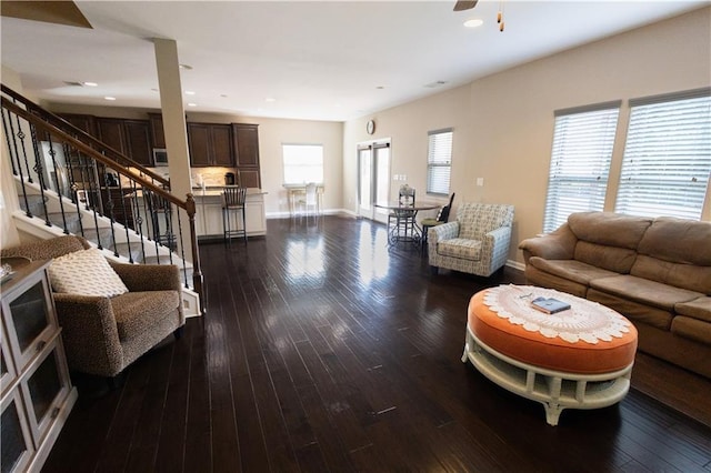 living room with ceiling fan, plenty of natural light, and dark hardwood / wood-style floors