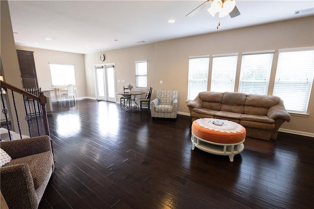 living room with ceiling fan, a wealth of natural light, and dark hardwood / wood-style floors