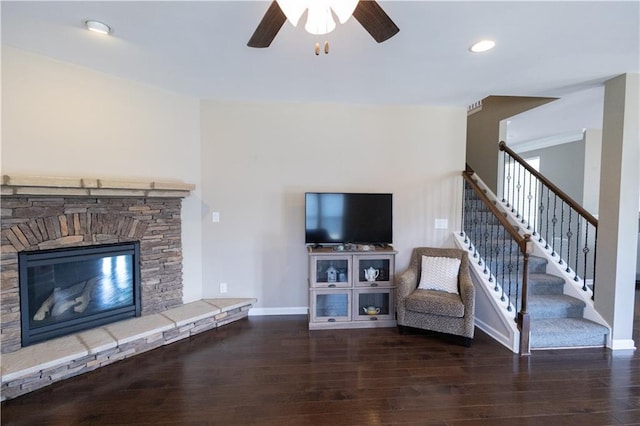 unfurnished living room with a fireplace, ceiling fan, and dark hardwood / wood-style floors