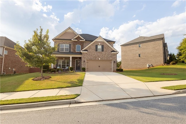 craftsman-style house featuring a garage, covered porch, and a front lawn