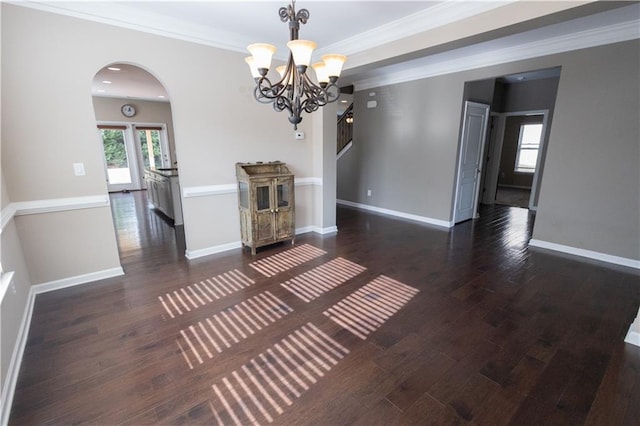 interior space with a notable chandelier, crown molding, and dark hardwood / wood-style floors