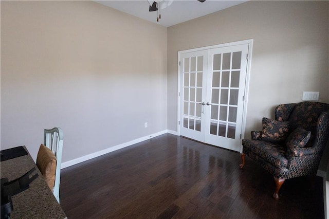 living area featuring french doors, ceiling fan, and dark wood-type flooring