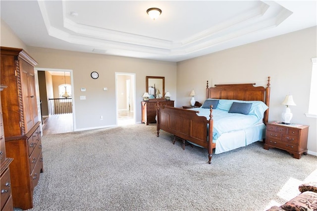 carpeted bedroom with a raised ceiling