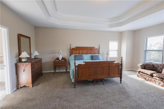 bedroom featuring a raised ceiling, ornamental molding, and carpet