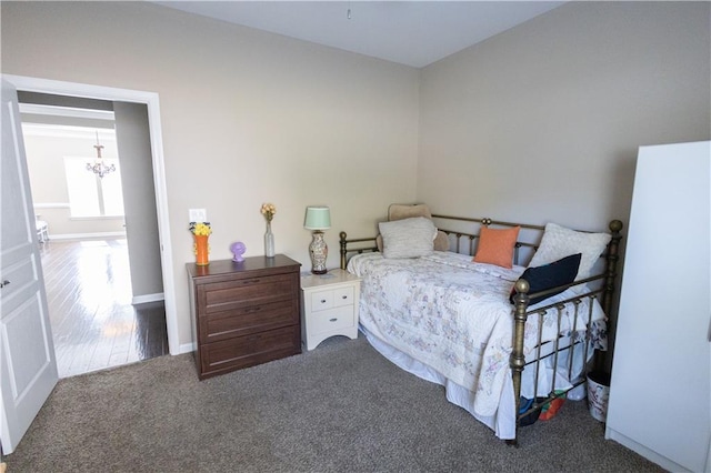 carpeted bedroom with a notable chandelier