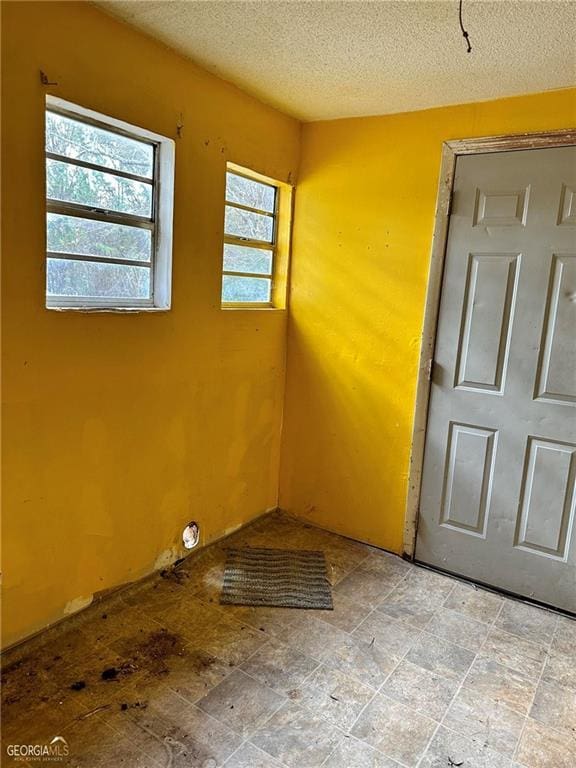 empty room featuring a textured ceiling
