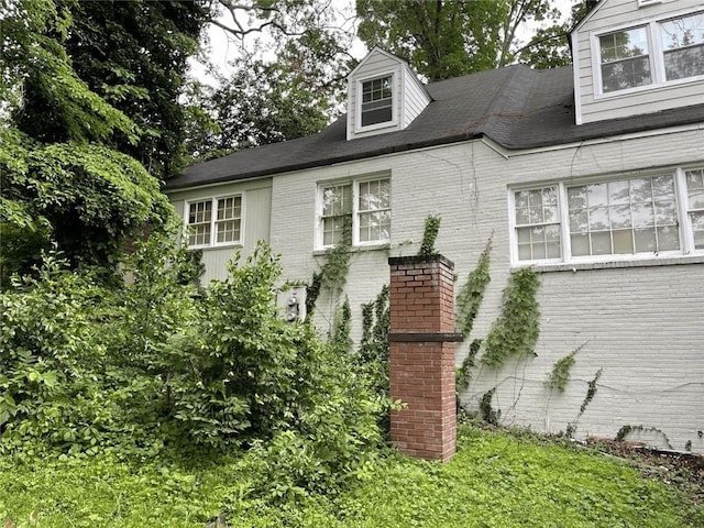 view of side of property with brick siding