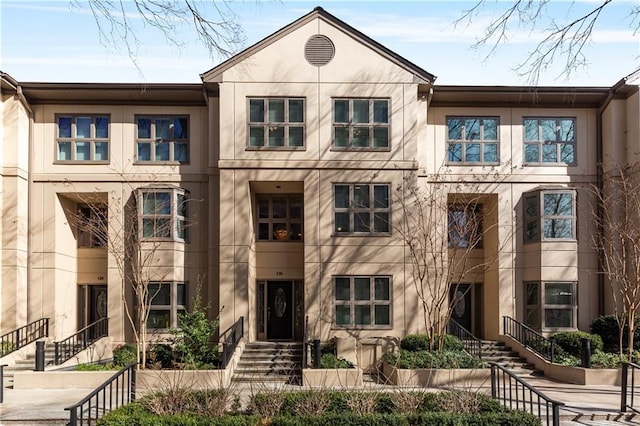 3475 Oak Valley Rd Unit 130, Atlanta, GA 30326 - townhome / multi-family property featuring stucco siding and stairs