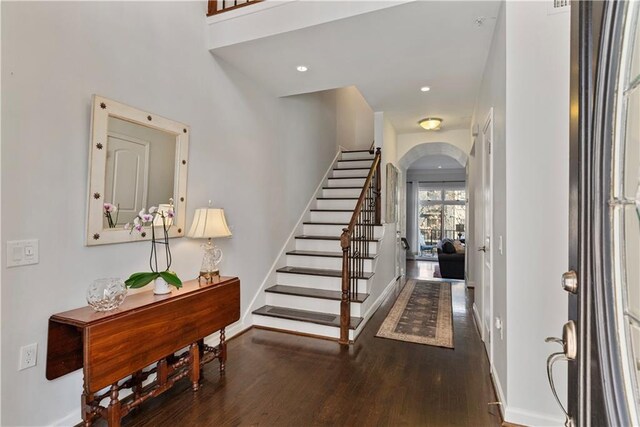 3475 Oak Valley Rd Unit 130, Atlanta, GA 30326 - foyer with baseboards, arched walkways, wood finished floors, and stairs