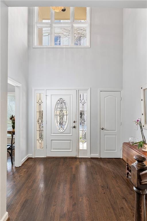 3475 Oak Valley Rd Unit 130, Atlanta, GA 30326 - foyer entrance featuring baseboards, a towering ceiling, and dark wood-type flooring