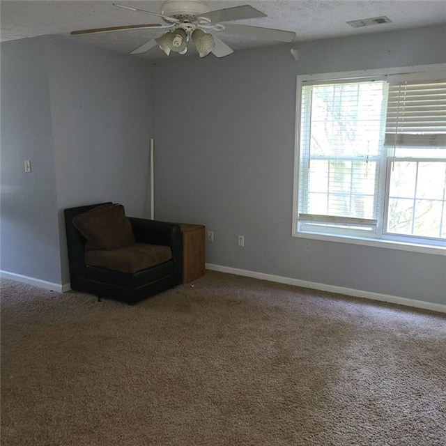 unfurnished room featuring carpet floors, a textured ceiling, and ceiling fan