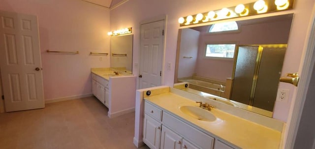 full bathroom with a garden tub, a shower stall, baseboards, and vanity