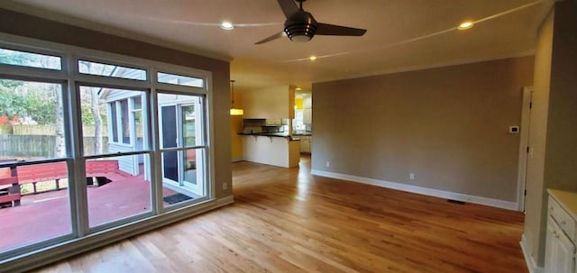 empty room featuring a ceiling fan, recessed lighting, light wood-style flooring, and baseboards