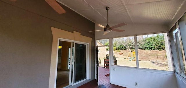 unfurnished sunroom featuring a ceiling fan and lofted ceiling