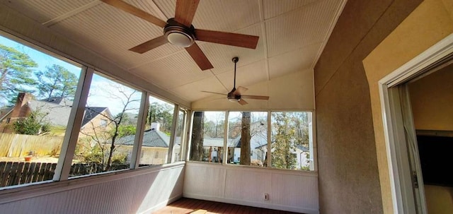 unfurnished sunroom featuring lofted ceiling and ceiling fan