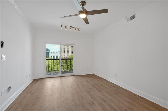 1075 Peachtree Walk NE Unit A421, Atlanta, GA 30309 - spare room with wood finished floors, ceiling fan, baseboards, and rail lighting