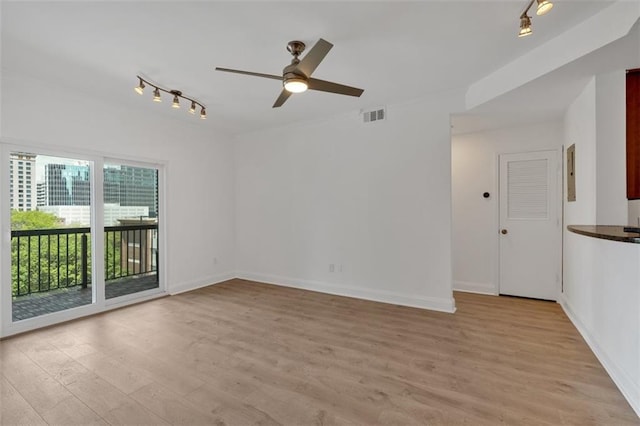 1075 Peachtree Walk NE Unit A421, Atlanta, GA 30309 - unfurnished room featuring track lighting, a ceiling fan, light wood-type flooring, and baseboards