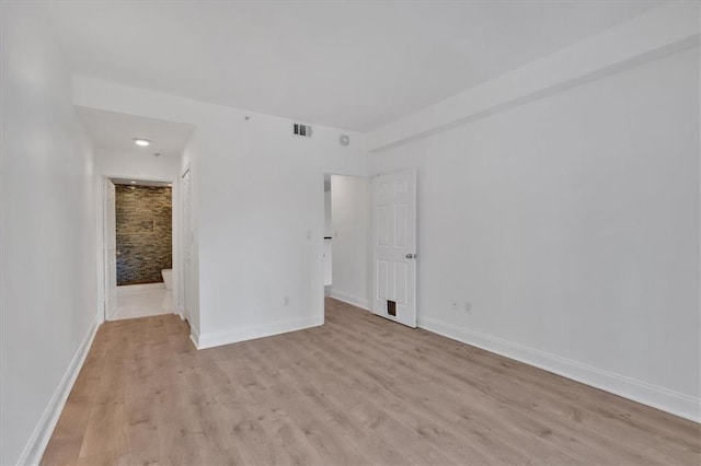 1075 Peachtree Walk NE Unit A421, Atlanta, GA 30309 - empty room with light wood-style flooring and baseboards