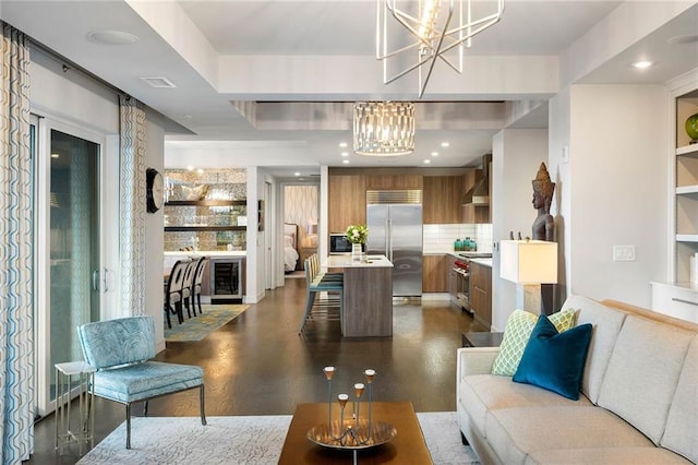 living room with dark wood-type flooring, beverage cooler, a chandelier, and plenty of natural light