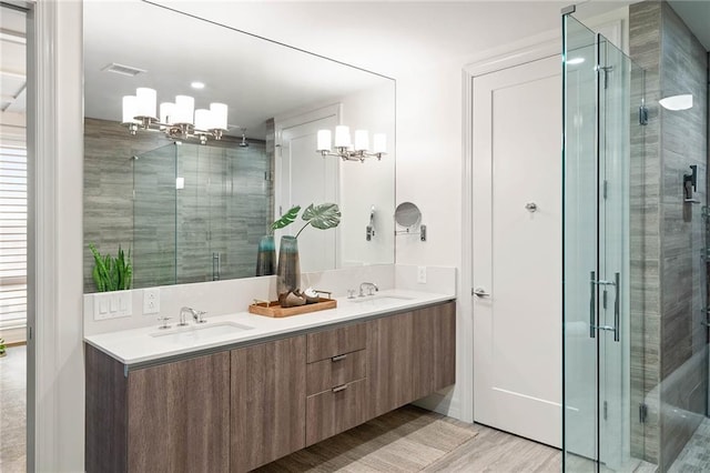 bathroom with a shower with door, vanity, and hardwood / wood-style flooring