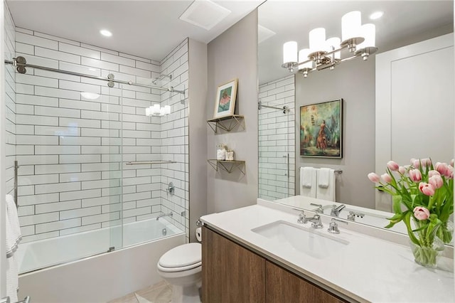 full bathroom featuring vanity, toilet, and shower / bath combination with glass door