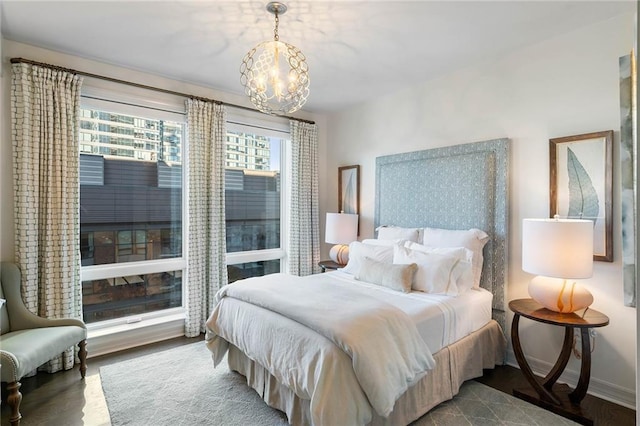 bedroom featuring hardwood / wood-style flooring and a notable chandelier