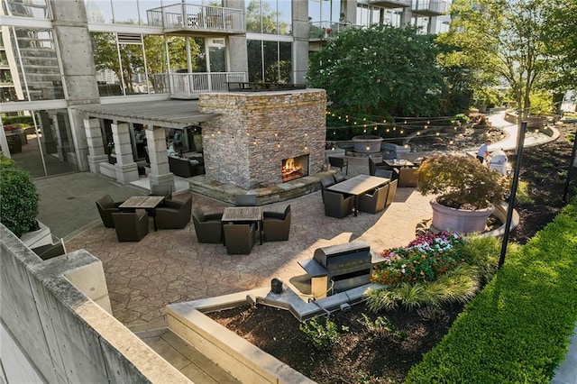 view of patio / terrace featuring an outdoor living space with a fireplace and a balcony