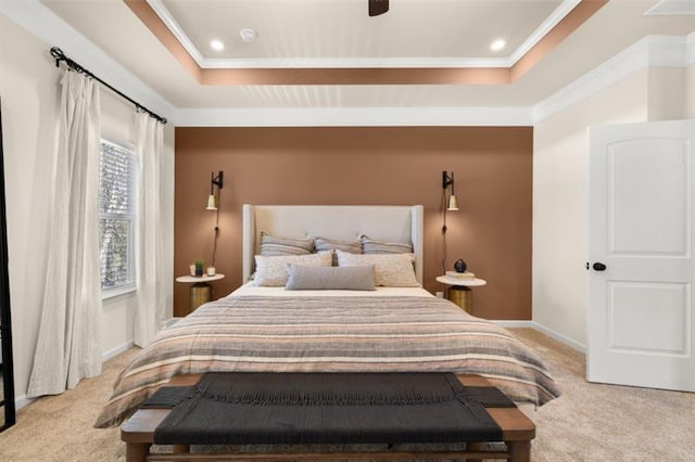 bedroom with crown molding, ceiling fan, a tray ceiling, and light carpet