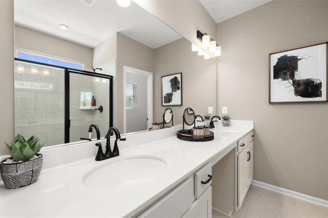 bathroom with tile patterned floors, vanity, and a shower with door