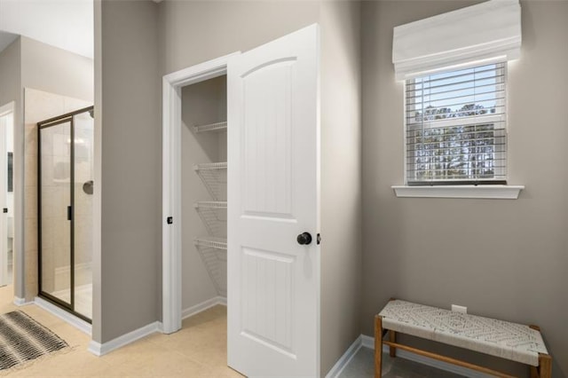 interior space with tile patterned floors and an enclosed shower