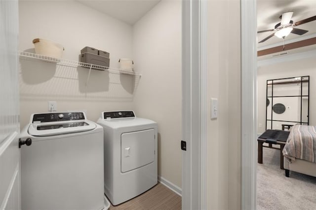 washroom with ceiling fan, washing machine and dryer, and light carpet