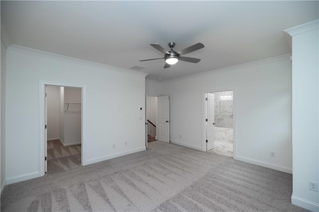 unfurnished bedroom with a walk in closet, light colored carpet, ceiling fan, and a closet