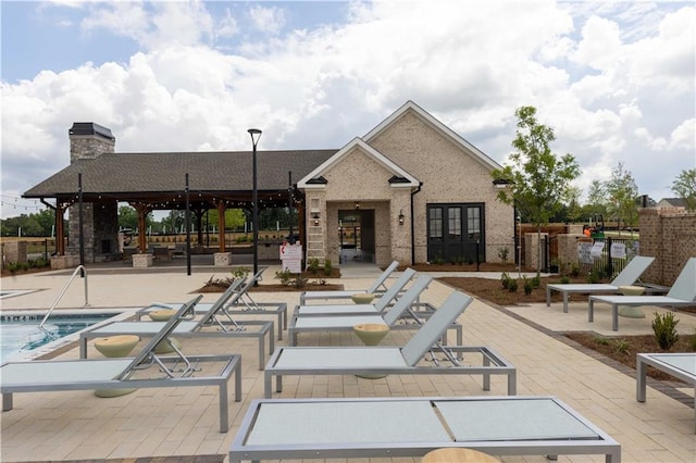 view of pool featuring french doors and a patio