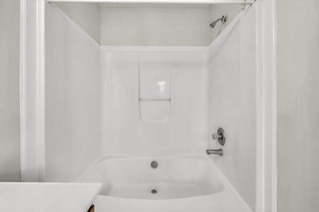 bathroom featuring shower / tub combination and vanity