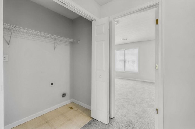 clothes washing area featuring light carpet and hookup for an electric dryer