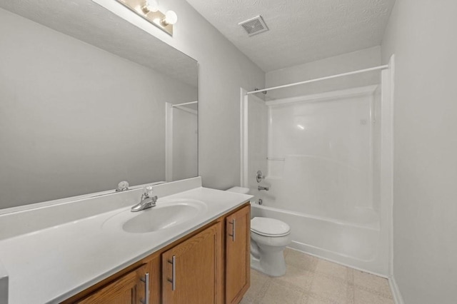 full bathroom featuring vanity, toilet, bathing tub / shower combination, and a textured ceiling