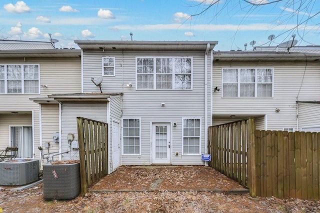 rear view of house featuring central AC